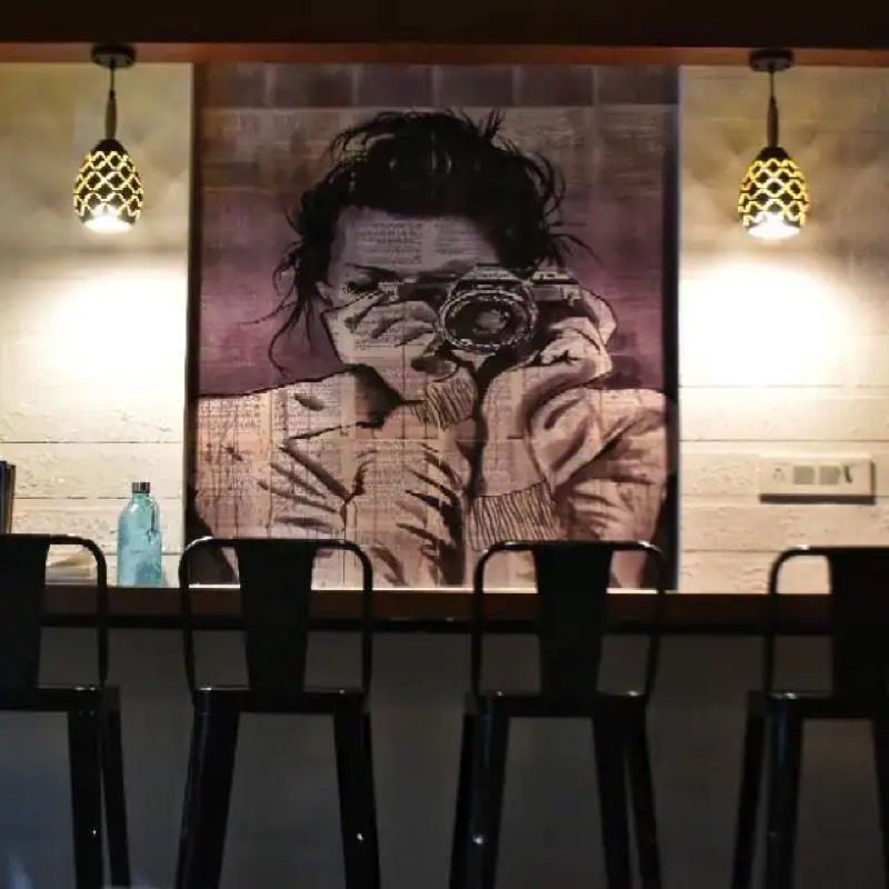 Bar seating under a black and white photographer mural inside the cafe
